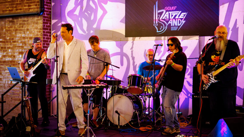 Musicians stand on stage during performance