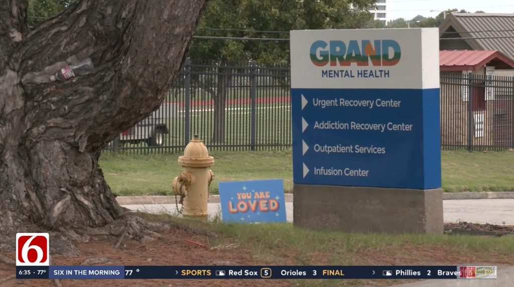 An outdoor sign for Grand Mental Health